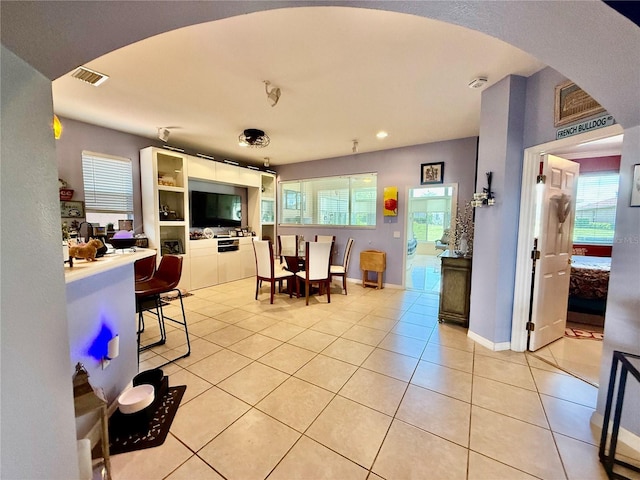 10075 SW 91st Pl, Ocala, FL 34481 - dining area with light tile patterned flooring, healthy amount of natural light, arched walkways, baseboards, and recessed lighting
