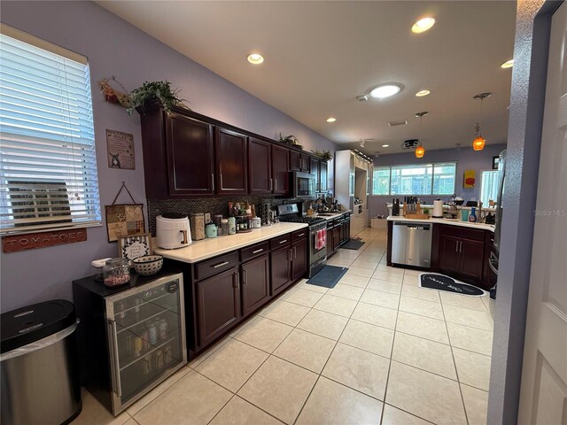 10075 SW 91st Pl, Ocala, FL 34481 - kitchen with stainless steel appliances, dark brown cabinetry, light countertops, decorative backsplash, and recessed lighting