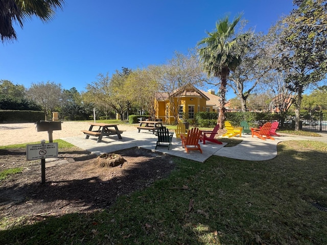 8801 Villa View Cir Unit 207, Orlando, FL 32821 - view of playground with a patio area, a lawn, and an outdoor fire pit