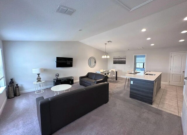 145 Kenny Blvd, Haines City, FL 33844 - living area featuring light carpet, lofted ceiling, baseboards, recessed lighting, and a chandelier