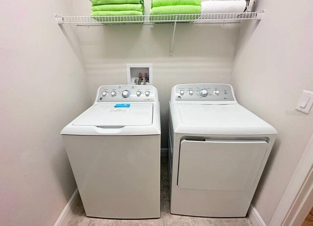 145 Kenny Blvd, Haines City, FL 33844 - clothes washing area featuring washer and clothes dryer and baseboards