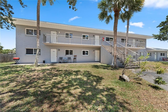 238 Chandler St Unit 102, Cape Canaveral, FL 32920 - back of house with stucco siding, stairway, and a patio