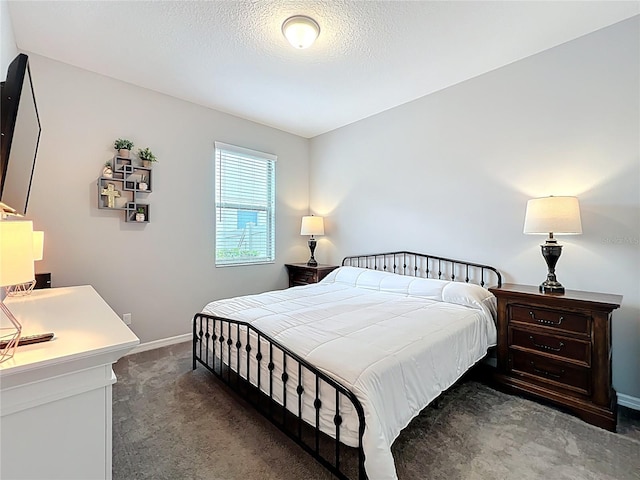 carpeted bedroom with baseboards and a textured ceiling