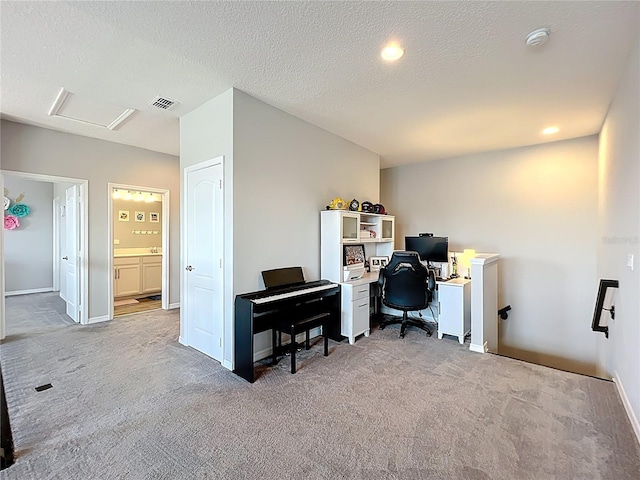 office with carpet floors, attic access, baseboards, a textured ceiling, and recessed lighting