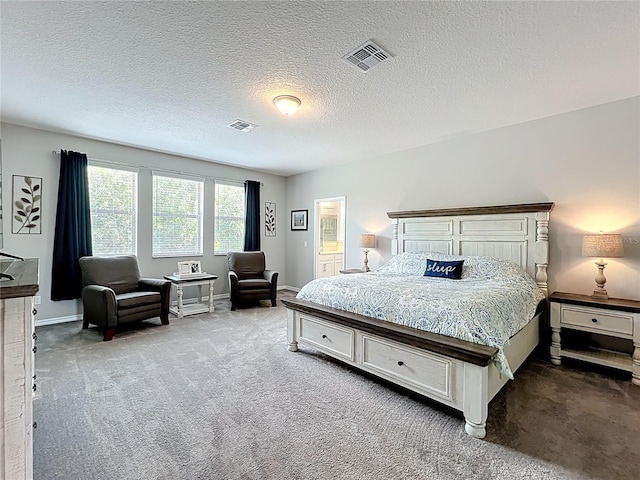 bedroom featuring carpet, baseboards, and a textured ceiling