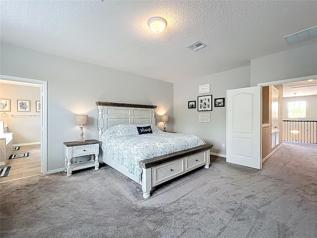 carpeted bedroom with a textured ceiling and baseboards
