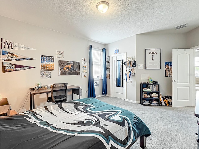 bedroom with light carpet, a textured ceiling, and baseboards