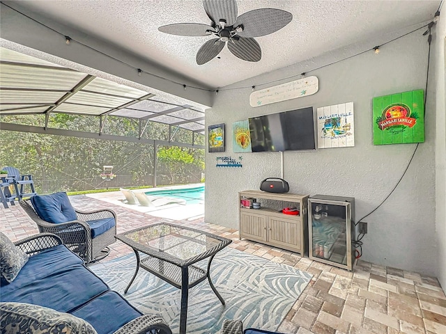 view of patio featuring a ceiling fan, an outdoor pool, and a lanai
