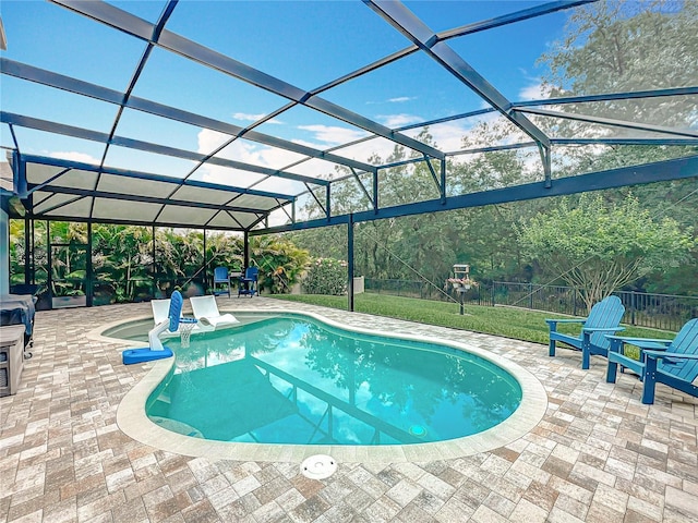 outdoor pool featuring a patio area and a lanai