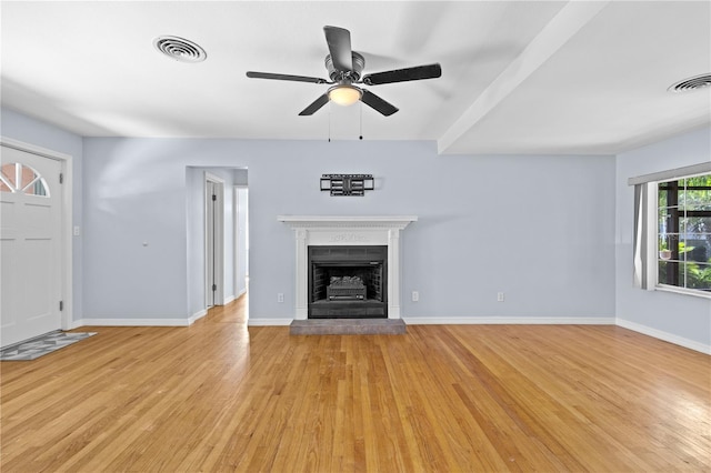 360 W University Ave, Orange City, FL 32763 - unfurnished living room featuring light wood-style flooring, a ceiling fan, a fireplace with raised hearth, and baseboards