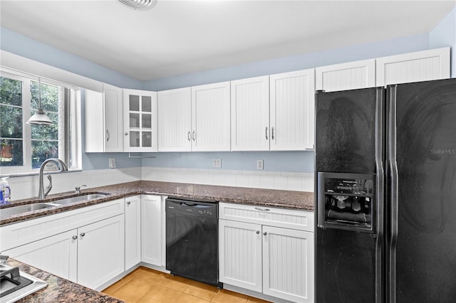 360 W University Ave, Orange City, FL 32763 - kitchen with black appliances, a sink, white cabinets, and dark stone counters