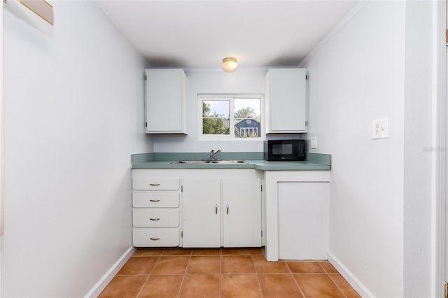 360 W University Ave, Orange City, FL 32763 - kitchen featuring black microwave, light tile patterned floors, white cabinetry, and baseboards