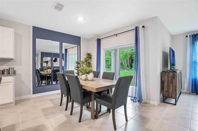dining space with plenty of natural light, baseboards, and light tile patterned floors
