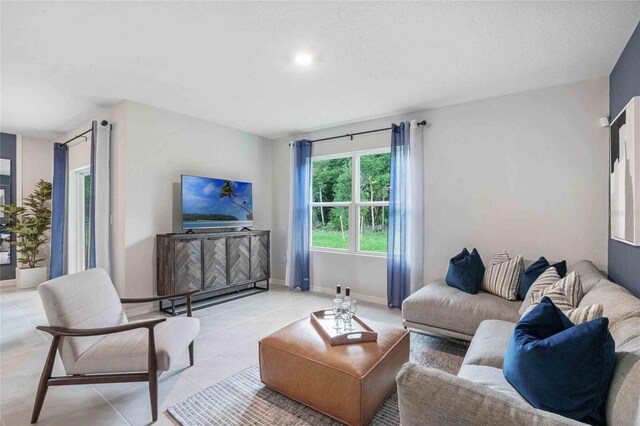 living room featuring light tile patterned floors and baseboards