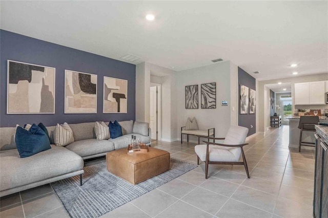 living room with light tile patterned flooring and recessed lighting