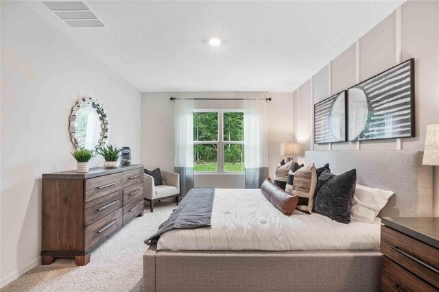 bedroom featuring light colored carpet and baseboards