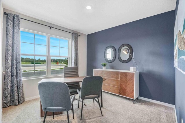 carpeted home office featuring baseboards