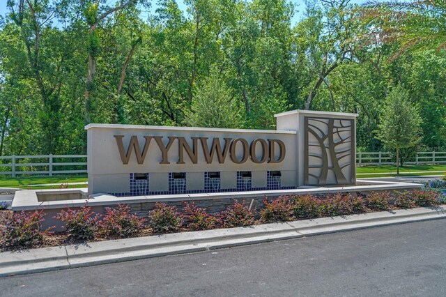 community / neighborhood sign with fence