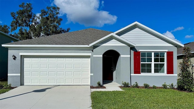 single story home with an attached garage, driveway, a front lawn, and stucco siding