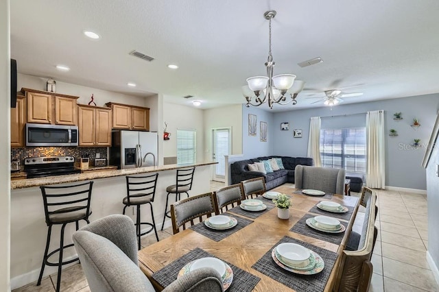 3055 Beach Palm Ave, Kissimmee, FL 34747 - dining space with plenty of natural light, a chandelier, baseboards, light tile patterned flooring, and recessed lighting