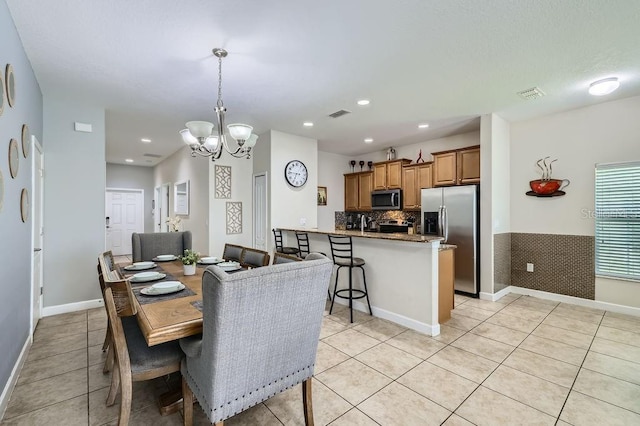 3055 Beach Palm Ave, Kissimmee, FL 34747 - dining area featuring light tile patterned floors, a chandelier, baseboards, and recessed lighting