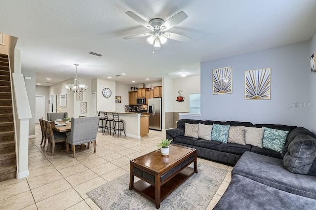 3055 Beach Palm Ave, Kissimmee, FL 34747 - living area with stairway, light tile patterned flooring, a chandelier, ceiling fan, and recessed lighting