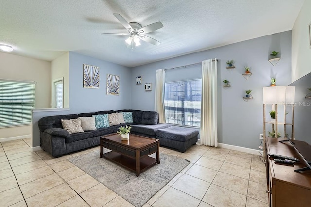 3055 Beach Palm Ave, Kissimmee, FL 34747 - living room with a ceiling fan, a textured ceiling, baseboards, and light tile patterned floors