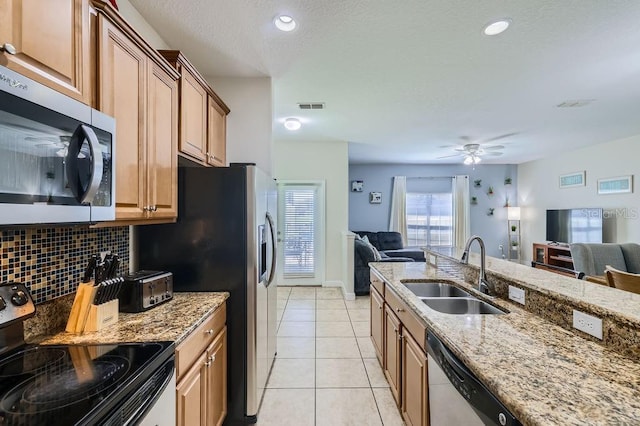 3055 Beach Palm Ave, Kissimmee, FL 34747 - kitchen featuring a sink, appliances with stainless steel finishes, open floor plan, light stone counters, and recessed lighting