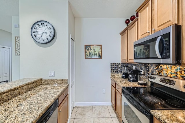 3055 Beach Palm Ave, Kissimmee, FL 34747 - kitchen featuring appliances with stainless steel finishes, light stone counters, tasteful backsplash, and light tile patterned flooring