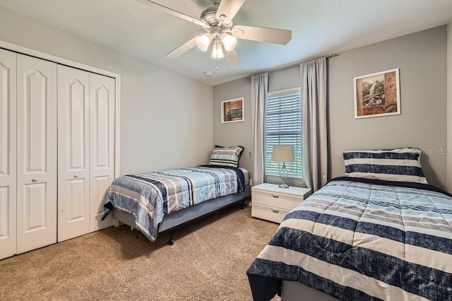 3055 Beach Palm Ave, Kissimmee, FL 34747 - carpeted bedroom with a closet, ceiling fan, and a textured ceiling
