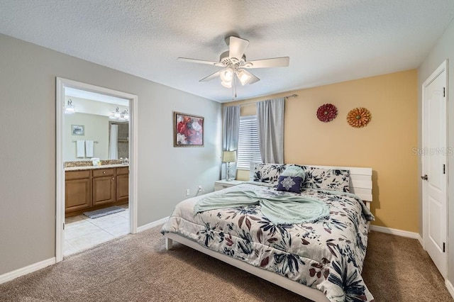 3055 Beach Palm Ave, Kissimmee, FL 34747 - bedroom with light carpet, a textured ceiling, connected bathroom, baseboards, and ceiling fan