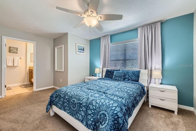 3055 Beach Palm Ave, Kissimmee, FL 34747 - bedroom featuring carpet flooring, a textured ceiling, baseboards, a ceiling fan, and connected bathroom