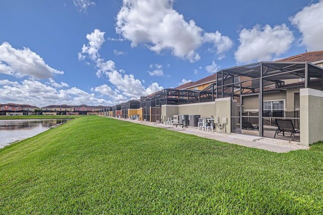 3055 Beach Palm Ave, Kissimmee, FL 34747 - view of grassy yard with a water view and glass enclosure