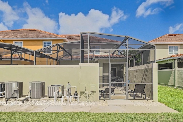 3055 Beach Palm Ave, Kissimmee, FL 34747 - rear view of house featuring central AC unit, stucco siding, and a patio area