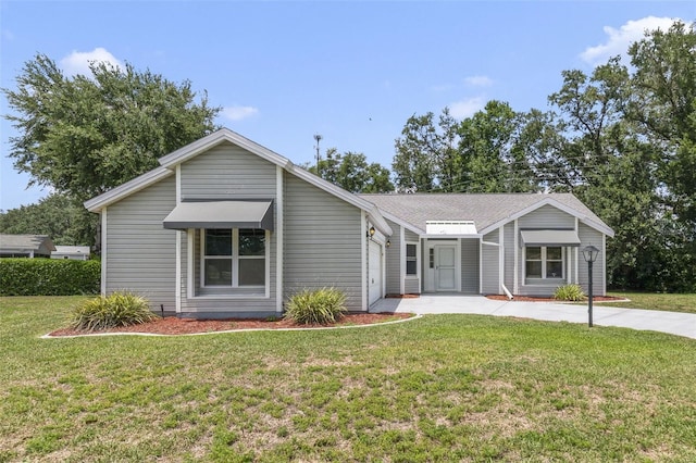 1243 Tangerine Cir, Lady Lake, FL 32159 - view of front of house featuring concrete driveway, a front lawn, and a garage