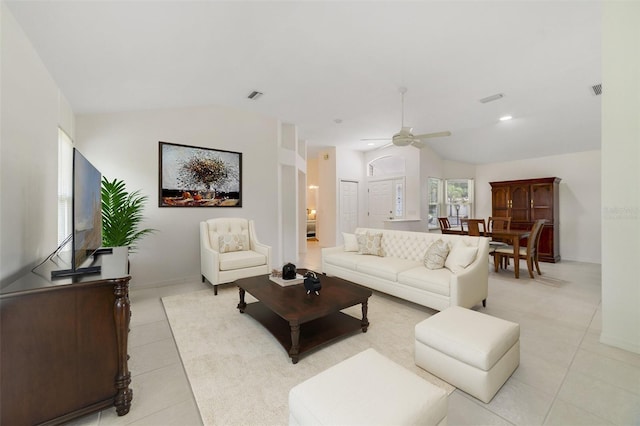 1243 Tangerine Cir, Lady Lake, FL 32159 - living room featuring light tile patterned flooring, vaulted ceiling, a ceiling fan, and baseboards