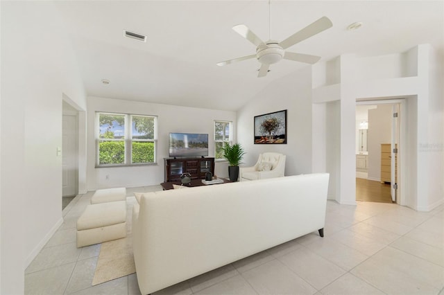 1243 Tangerine Cir, Lady Lake, FL 32159 - living room featuring lofted ceiling, light tile patterned flooring, baseboards, and a ceiling fan