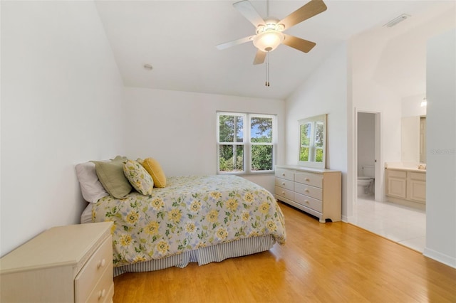 1243 Tangerine Cir, Lady Lake, FL 32159 - bedroom with light wood-style floors, connected bathroom, high vaulted ceiling, and a ceiling fan