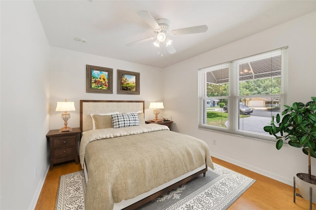 1243 Tangerine Cir, Lady Lake, FL 32159 - bedroom with baseboards, light wood-style floors, and ceiling fan