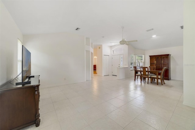 1243 Tangerine Cir, Lady Lake, FL 32159 - living room featuring vaulted ceiling, ceiling fan, light tile patterned floors, and baseboards