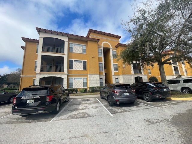 view of property featuring uncovered parking