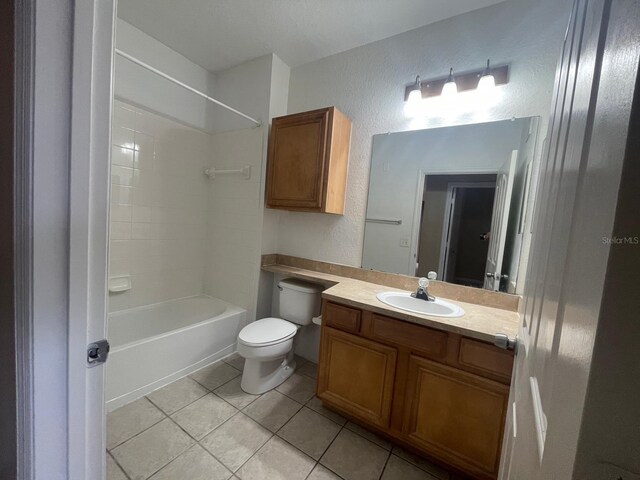full bathroom with tile patterned flooring, toilet, a textured wall, vanity, and  shower combination