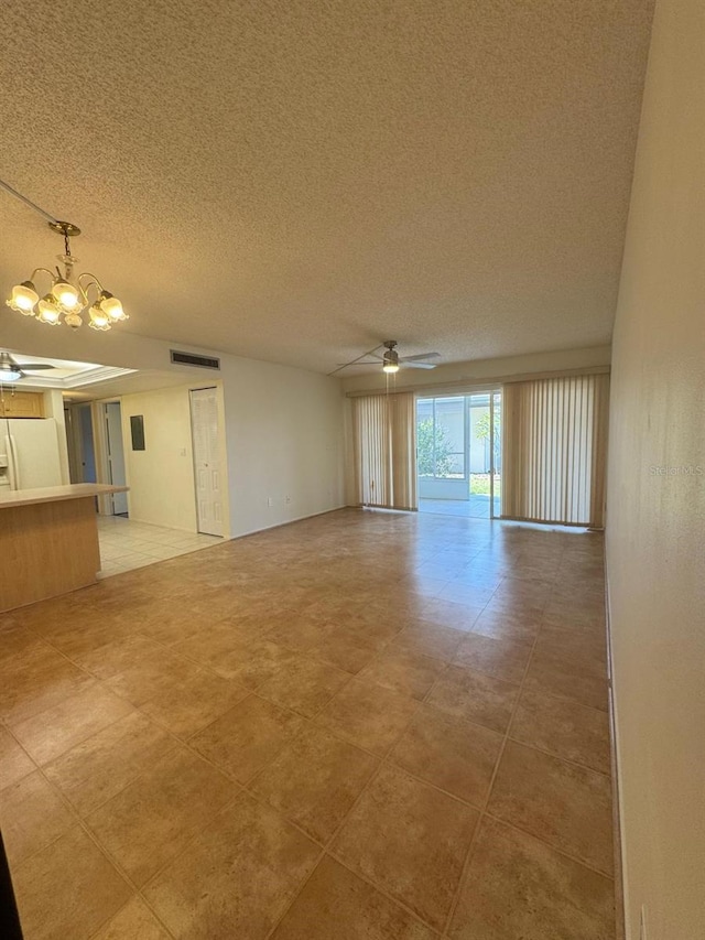 21260 Brinson Ave Unit 109, Port Charlotte, FL 33952 - unfurnished living room featuring ceiling fan, a chandelier, and a textured ceiling
