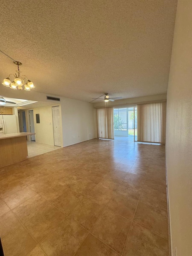 21260 Brinson Ave Unit 109, Port Charlotte, FL 33952 - unfurnished living room featuring a chandelier, ceiling fan, and a textured ceiling
