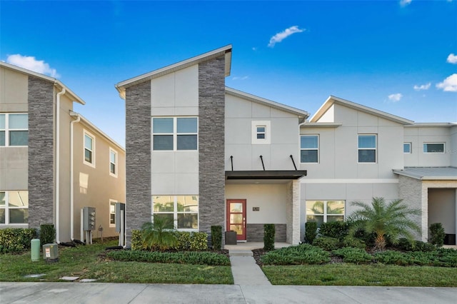 1128 Challenge Dr, Davenport, FL 33896 - contemporary house featuring stone siding and stucco siding