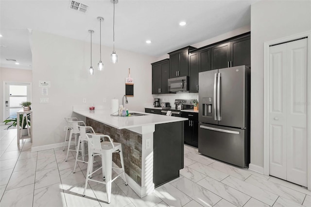 1128 Challenge Dr, Davenport, FL 33896 - kitchen featuring stainless steel appliances, light marble finish floors, dark cabinets, and recessed lighting