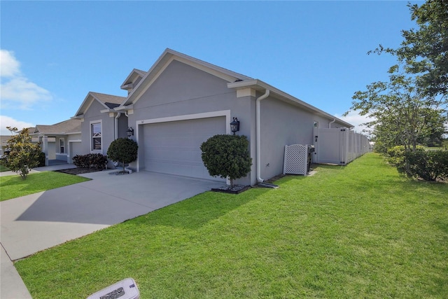 view of front facade with stucco siding, an attached garage, and concrete driveway