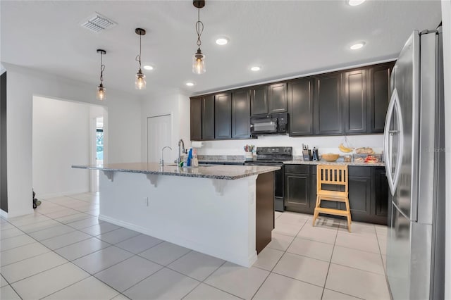 kitchen with black appliances, light stone countertops, a breakfast bar area, recessed lighting, and decorative light fixtures