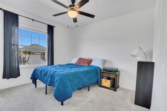 carpeted bedroom with baseboards and a ceiling fan