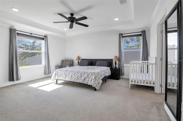 bedroom featuring carpet, a raised ceiling, ornamental molding, recessed lighting, and a ceiling fan